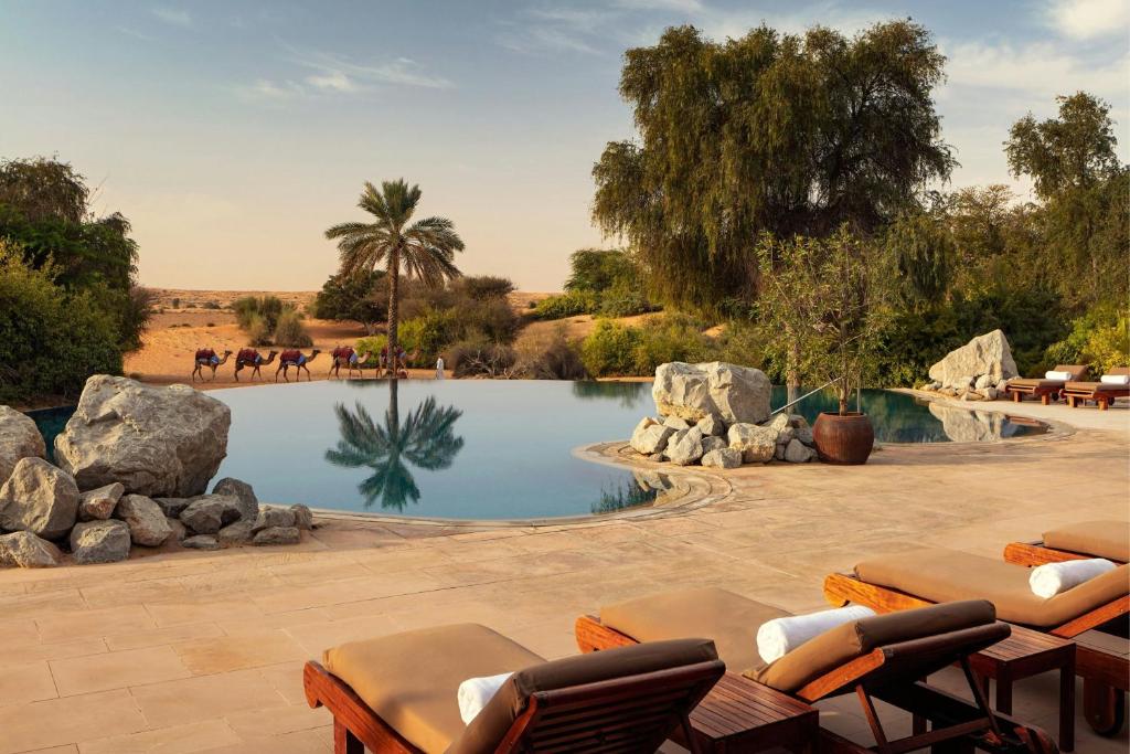 Al Maha Desert Resort honeymoon suite with private pool and Arabian oryx at sunset