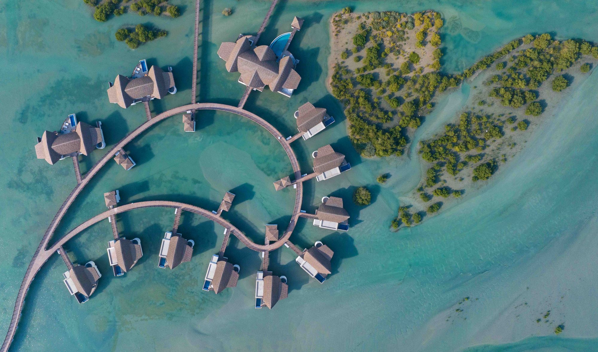 Anantara The Palm Dubai overwater villa with private pool at sunrise over Arabian Gulf