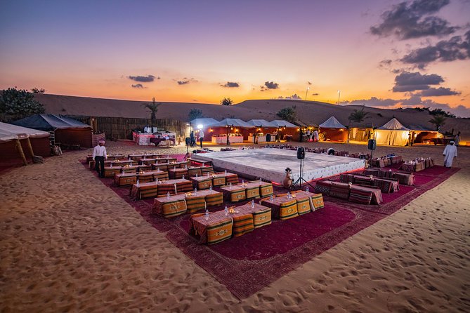 A 4x4 vehicle dune bashing over golden sand dunes at sunset during a Dubai desert safari