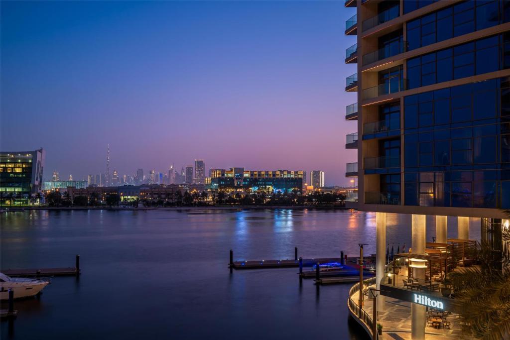 Hilton Dubai Creek Deira best 5 star hotel Old Dubai with Carlos Ott glass tower architecture
