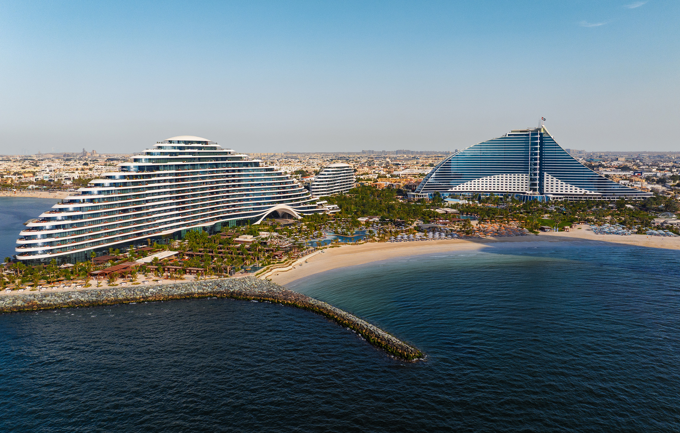 Jumeirah Beach Hotel wave shaped tower with Burj Al Arab view family hotel direct rooms
