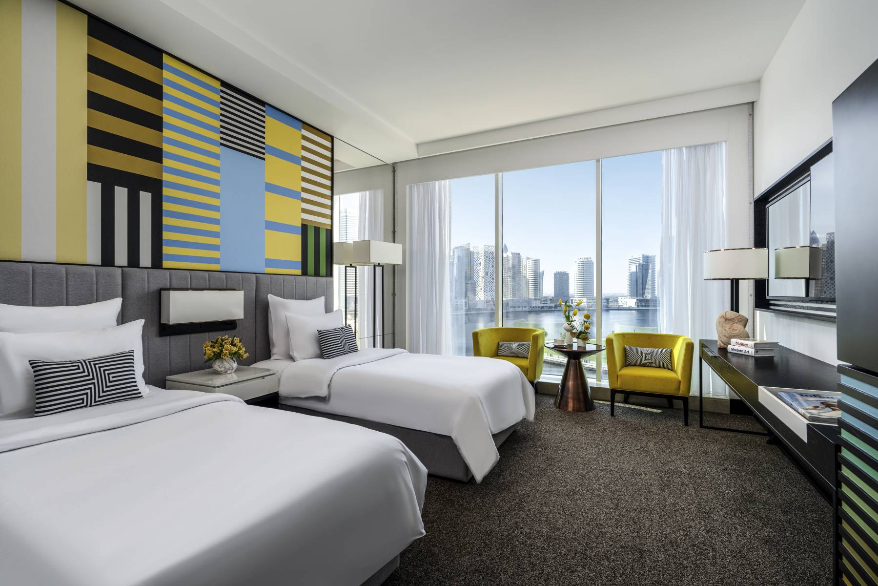 Pullman Dubai Downtown hotel on Dubai Canal in Business Bay with glass-walled pool terrace and skyline views