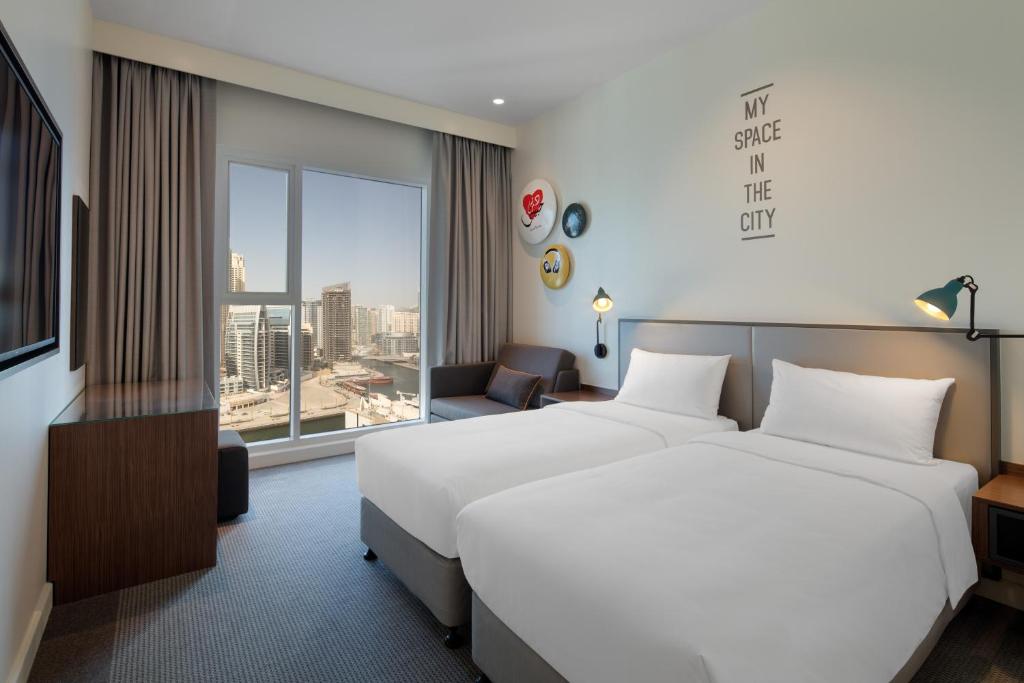 Rove Dubai Marina suite with jacuzzi on balcony overlooking Dubai Marina